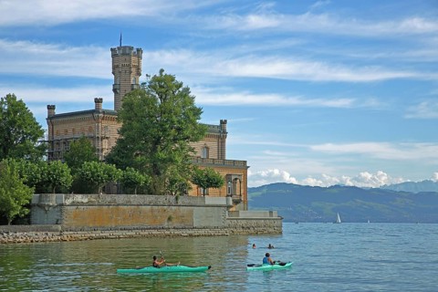 Two kayakers in the water, kayaking, lake, view, shore, landscape, mountains, Montfort Castle,
