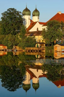 Romanesque Benedictine Abbey Seeon Monastery, monastery church St. Lambert with reflection in the