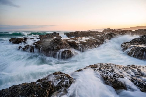Waves washing over rocks by the sea, long exposure, coastal landscape at sunset, Playa Cocalito,