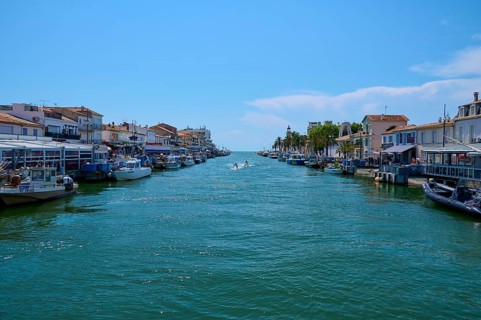 Coastal town with colourful houses, boats in the water, on a sunny day, summer, Le Grau-du-Roi,