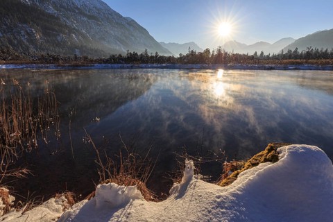 Mountains reflected in lake, evening light, sunbeams, snow, winter, seven springs, behind
