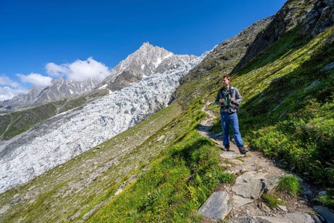 Mountaineer on the hiking trail La Jonction, mountain landscape with glacier Glacier des Bossons
