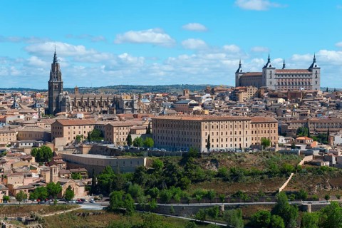 View of Toledo with historic buildings, a cathedral and trees under a blue sky, Cathedral,