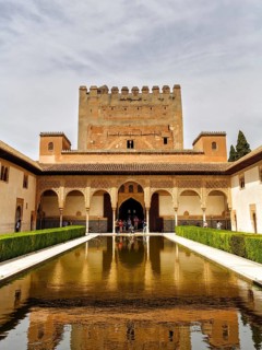 Myrtle courtyard with water basin and Torre de Comares, arabesque Moorish architecture, Nasrid
