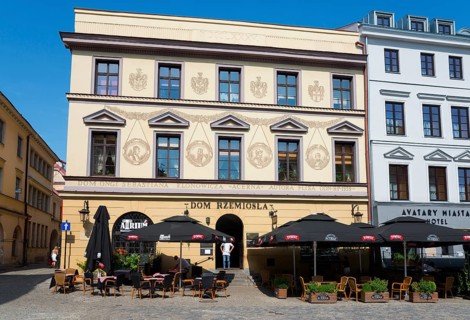 Historic facades with art and street cafés under a blue sky, Klonowica tenement house, Old Town,