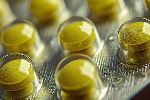 Close up of yellow medical pills in blister pack. Generative Ai, AI generated