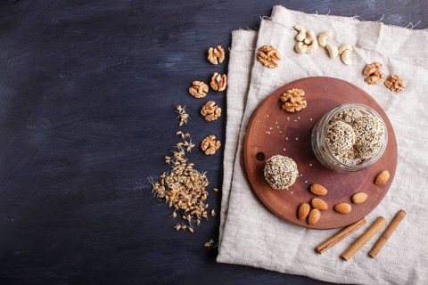Energy balls cakes with almonds, sesame, cashew, walnuts, dates and germinated wheat on wooden