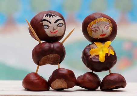 Two cute chestnut figures in front of a painted background, North Rhine-Westphalia, Germany, Europe