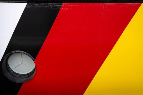 Black, red, gold, colours of the German flag on the ship's hull, Norddeich, East Frisia, Lower