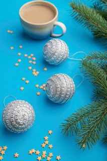 Christmas or New Year composition. Decorations, silver balls, fir and spruce branches, cup of
