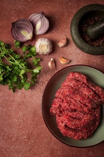 Fresh minced meat, raw, with spices and ingredients. on the table, preparation, top view