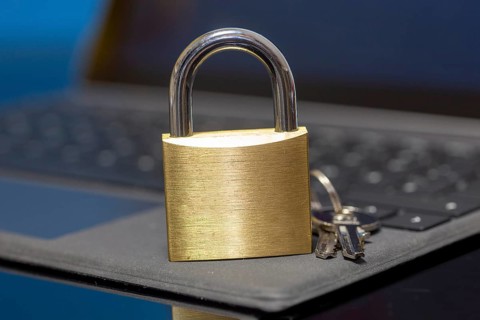 Padlock on a keyboard as a symbolic image for internet security, hacker attacks and so on