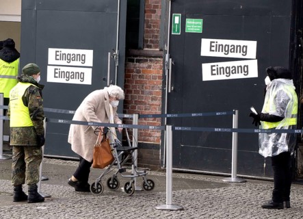 An elderly woman arriving at the vaccination centre in the Arena in Treptow, Berlin, 09.02.2021