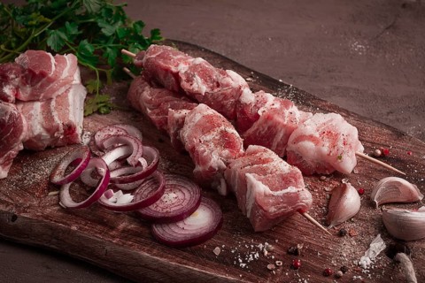 Raw pork meat, on wooden sticks, pickled kebab, with spices, top view, no people
