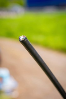 Close-up of a black cable with blurred green background, fibre optic installation, Calw district,