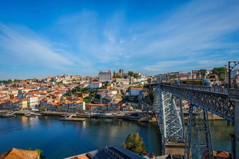 View of Porto city and Douro river and Dom Luis bridge I with metro tram from famous tourist