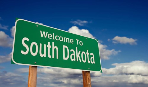 Welcome to south dakota green road sign over blue sky with some clouds