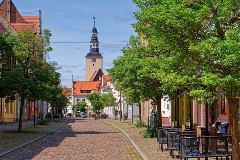 Residential and commercial buildings in Ernst-Thälmann-Straße, planted with trees and paved with