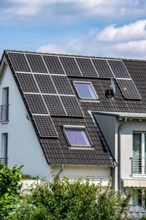Solar roof, solar panels on a pitched roof of a residential building, renewable energy generation