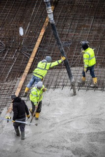 Construction site, concreting, the foundation of a building is concreted, the concrete is pumped