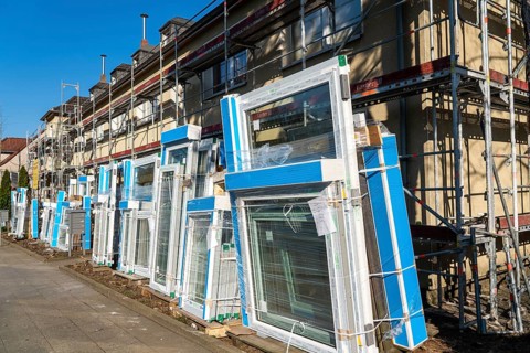 Energy-efficient refurbishment of residential buildings, older apartment block is scaffolded, gets
