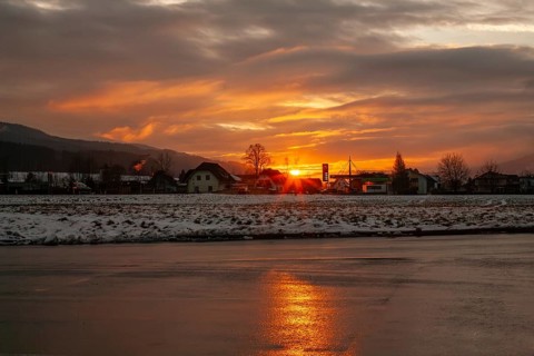 Sunset reflected in the asphalt of a car park, near Krieglach, Styria, Austria, Europe