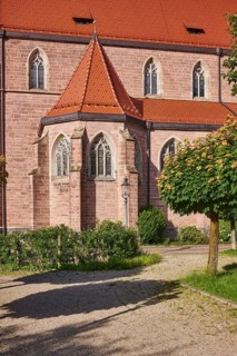 Church of St. Nicholas, façade, windows, roofs of red plain tiles, trees, greenery, sunlight,