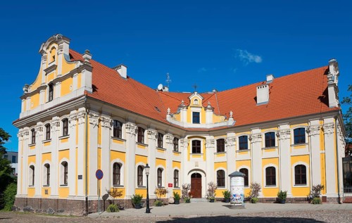 Historic baroque building with yellow façade and red tiled roof, Poznan Sródka, Former Philippine