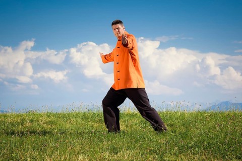 A man doing Qi-Gong in the green nature