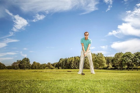 A picture of a young male golfer on the green