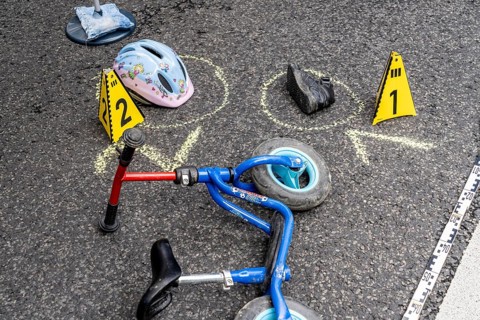 Markings at an accident scene with a balance bike for children, helmet, reenacted accident
