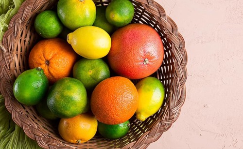 Assortment, citrus fruits, in a basket, close-up, top view, no people