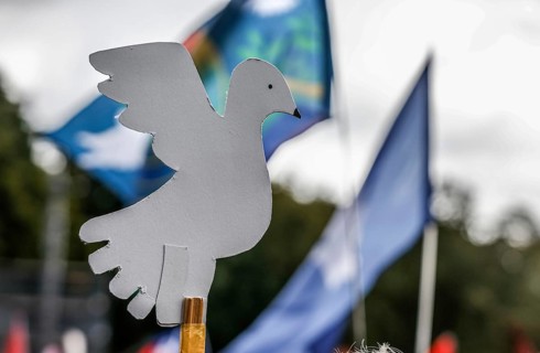 Demonstrator holding a peace dove during the demonstration Never again war, Berlin, 03.10.2024. The