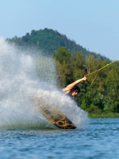 Heavy landing with wakeboard in the lake, water splashes, water sports, water skiing in the