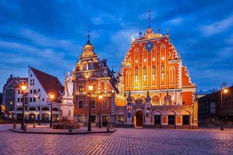 Riga Town Hall Square, House of the Blackheads and St. Roland Statue illuminated in the evening