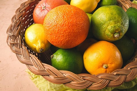 Assortment, citrus fruits, in a basket, close-up, top view, no people