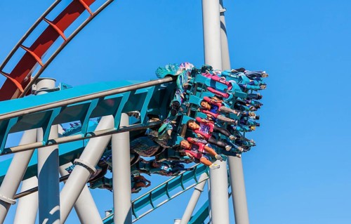 Theme park guests riding Dragon Challenge roller coaster in Wizarding World of Harry Potter at