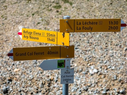 Hiking path, pass petit col Ferret, border Switzerland-Italy, signposts, view towards Val de