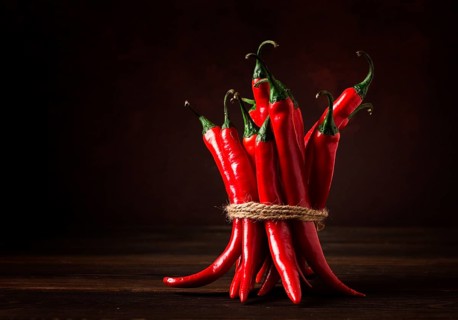 Bunch of red hot chili pepper, close-up, on a dark background, selective focus, no people, concept,