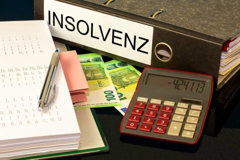 Symbolic image of insolvency: folders, calculators and euro banknotes