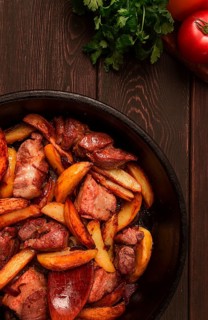 Ojakhuri, Traditional Georgian dish, fried potatoes with meat, in a clay frying pan, top view, no