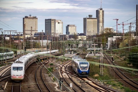 Train on the tracks west of Essen central station, skyline of the city centre, ICE train, North