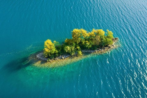 Bird's eye view of the chive island in the turquoise waters of Lake Walen in the canton of St.
