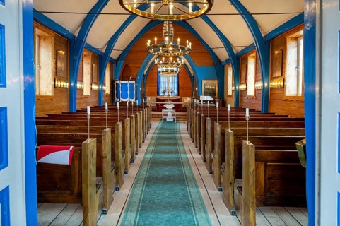 Church interior with several rows of wooden benches, church, Inuit settlement Ittoqqortoormiit,