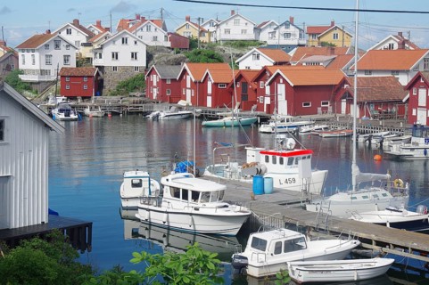 Harbour with several boats and traditional Scandinavian wooden houses, quiet atmosphere in a