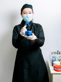 A dentist holding retainers, Female dentist holding dental retainers, Portrait of a female dentist