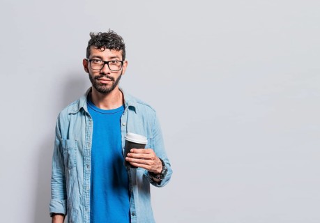 Portrait of young man with paper cup of coffee, A person with paper cup of coffee in isolated