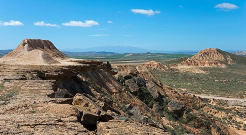 Vast landscape with a plateau and hills under a clear blue sky, Bardenas Reales Natural Park,