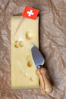 A piece of Swiss Emmental cheese and the Swiss flag
