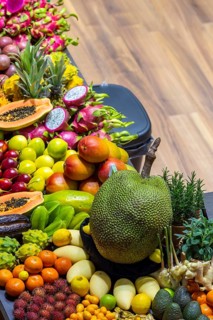 Exotic fruits, lychee, jackfruit, dragon fruit, mango and citrus fruits presented on a table,